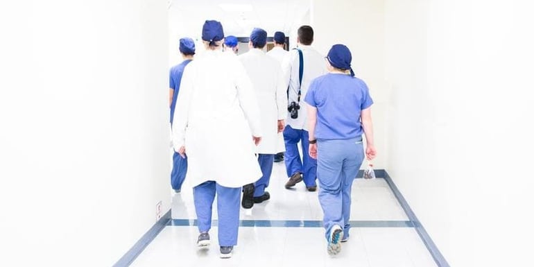 Doctors walking in a hospital hallway. Representing they can now focus on higher value activities due to  automation in healthcare