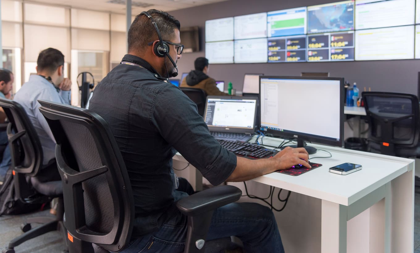  Auxis’ Costa Rica worker sitting in front of a computer