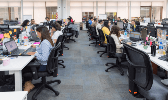 Auxis’ staff in Costa Rica doing their job in front of a computer.